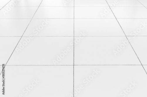 White tile floor background in perspective view. Clean  shiny  symmetry with grid line texture. For decoration in bathroom  kitchen and laundry room. And empty or copy space for product display also.