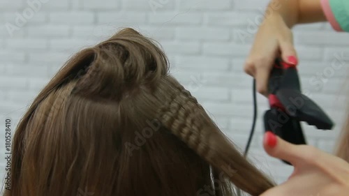 Professional Hair Dresser Used Hair Curler Iron for brunette Hair at beauty salon