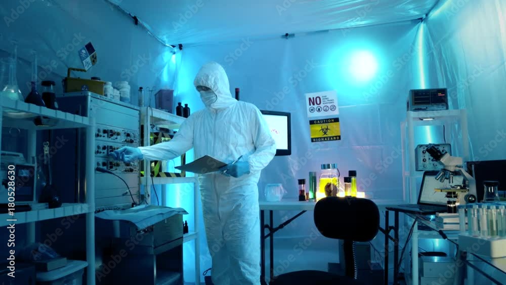 tech or scientist wearing hazmat gear in a sterile tent laboratory tech or scientist wearing hazmat gear in a sterile tent laboratory
