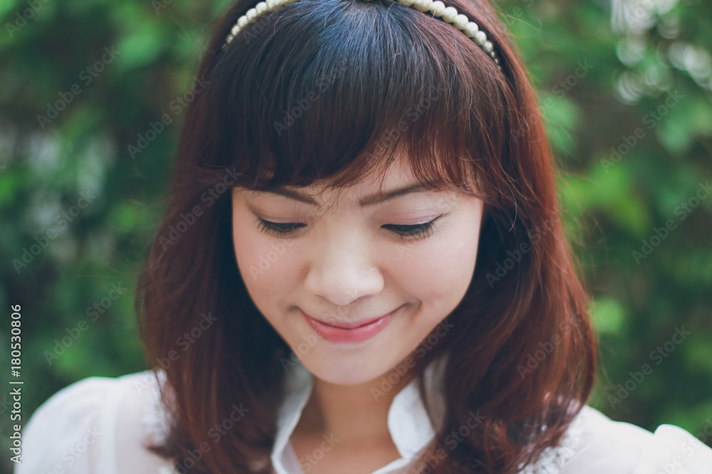 Close up of young pretty Asian woman in the garden. Close up of young pretty Asian woman in the garden.