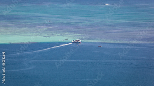 Kaneohe sandbar seascape background with boats and pristine, tropical, blue waters.
