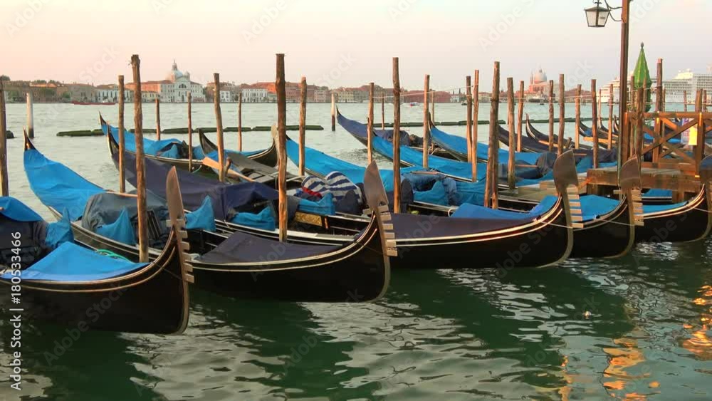 Moored gondolas on the background of the canale della Giudecca in the early morning. Venice Moored gondolas on the background of the canale della Giudecca in the early morning. Venice