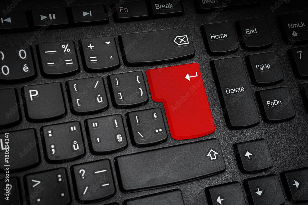 Top view of black keyboard with red Enter button Top view of black keyboard with red Enter button