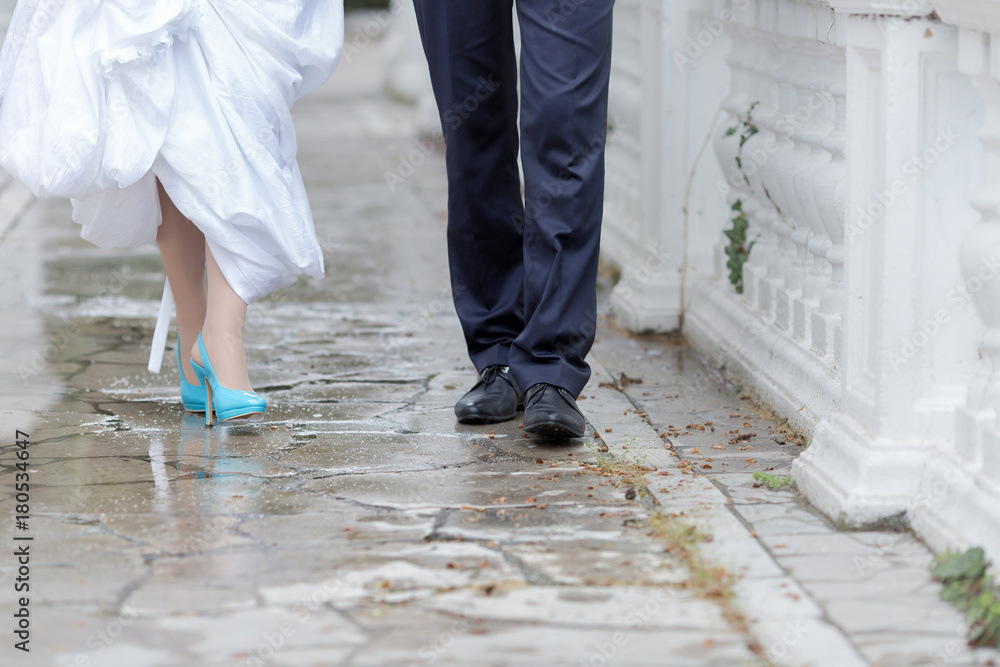 Groom and bride walking in the park in rainy day Groom and bride walking in the park in rainy day