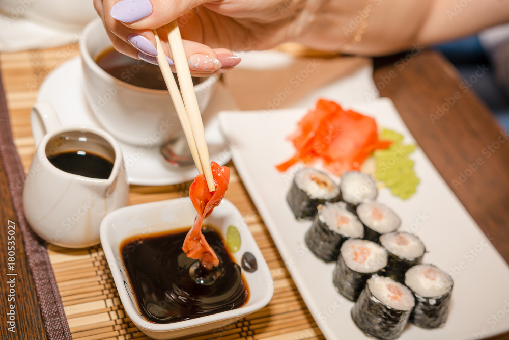 Eating sushi and rolls in a Japanese restaurant Eating sushi and rolls in a Japanese restaurant