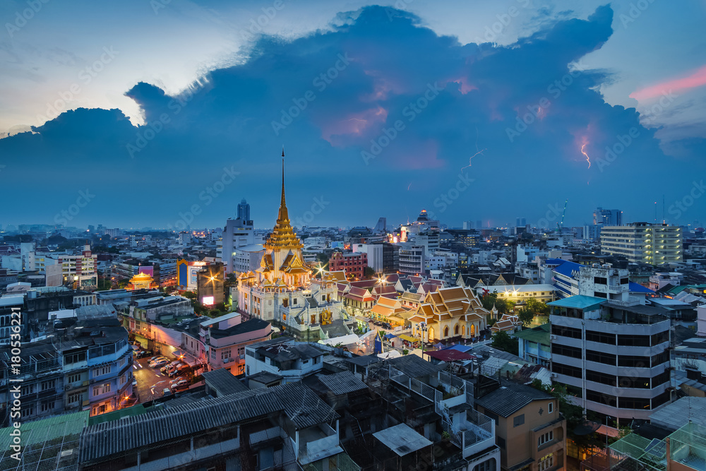 Aerial view cityscape & lightning Wat Traimit (Thai Temple) Inside of there have Golden Buddha that the biggest in the world in chinatown or yaowarat area in bangkok, Thailand.
