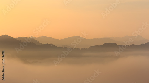 Sunrise and sea of mist at Khao Phanoen Thung, Kaeng Krachan National Park in Thailand photo