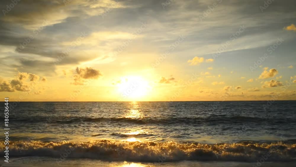 Sunset of sun setting over pacific ocean on windy evening Sunset of sun setting over pacific ocean on windy evening