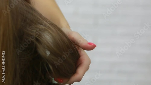 A professional stylist makes a hairstyle for the model. Fashion world.