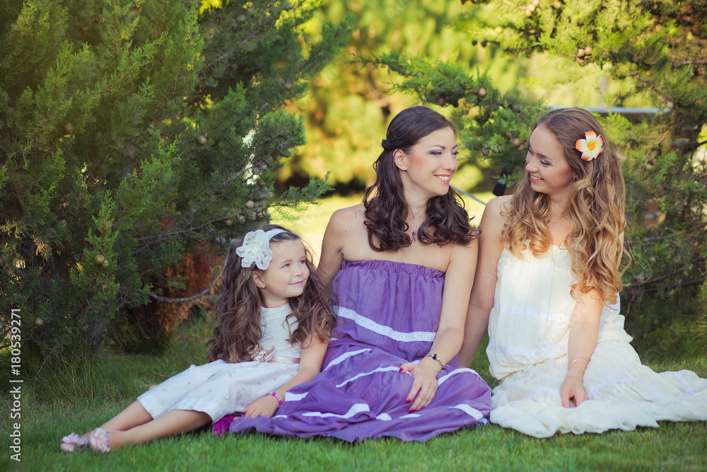 Stunning Brunette blond chestnut blue eyes sisters girls wearing stylish white purple dress enjoying life time together summer sunny day in garden forest on green grass happy smiling Stunning Brunette blond chestnut blue eyes sisters girls wearing stylish white purple dress enjoying life time together summer sunny day in garden forest on green grass happy smiling