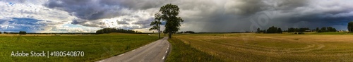 Super panorama of the Swedish flatlands with clear sky’s on one side and dark clouds lurking on the other.         