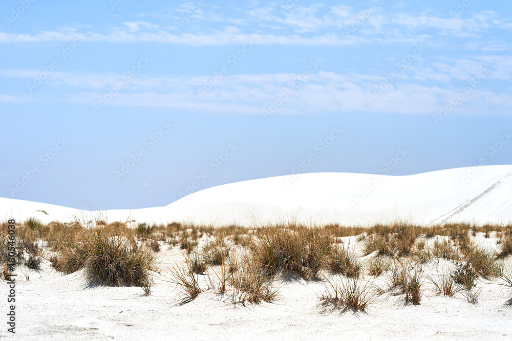 Blue sky and clouds and white sand on White Sands National Monument in New Mexico Blue sky and clouds and white sand on White Sands National Monument in New Mexico