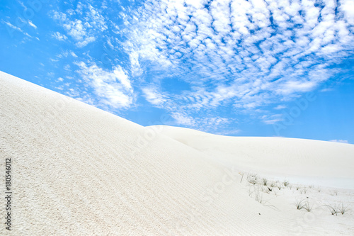 Blue sky and clouds and white sand on White Sands National Monument in New Mexico