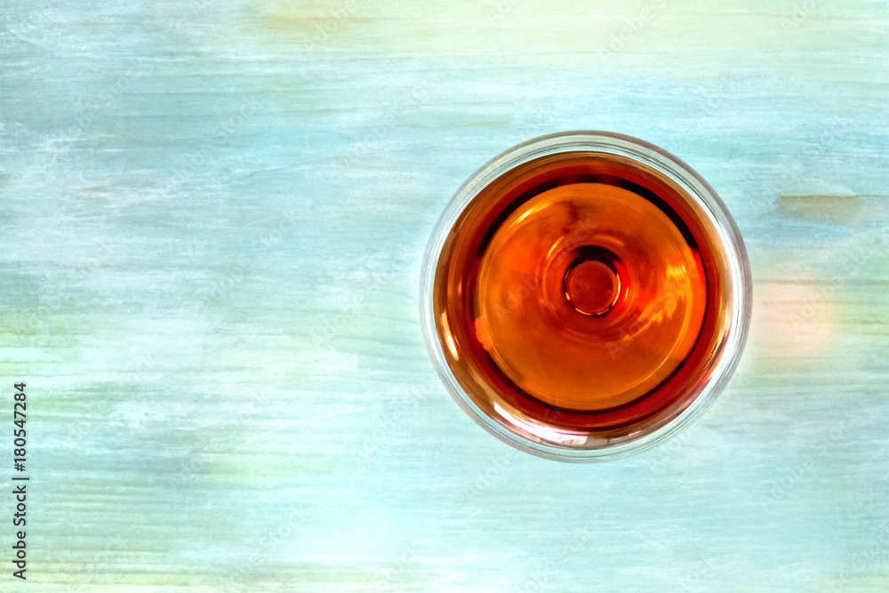Vibrant wine glass on teal background with copy space