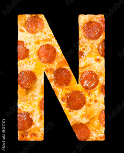 letter N cut out of pizza with peperoni photo