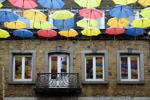 colorful hanging umbrellas, decoration in the shopping street in the old town of Bastogne, Belgium photo