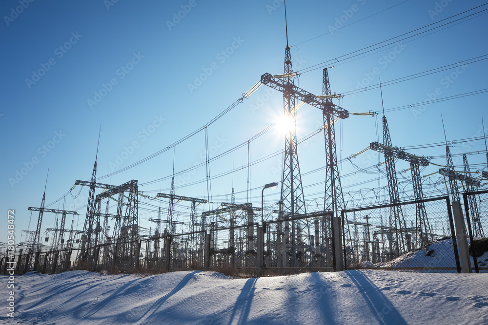 Obraz premium High voltage power lines in the winter. Thermal power plant. High-voltage transformer substation.