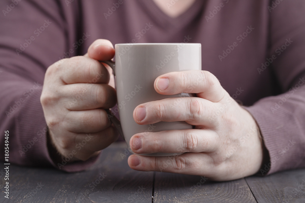 hands holding mug of hot drink, close-up hands holding mug of hot drink, close-up