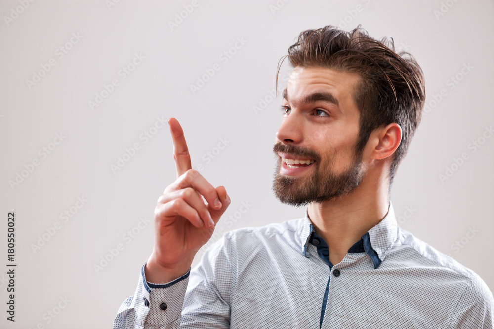 Studio shot portrait of young businessman who is having an idea. Studio shot portrait of young businessman who is having an idea.