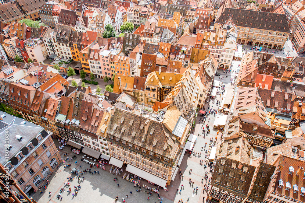 Naklejka premium Top cityscape view on the cathedral square crowded with people in the old town of Strasbourg city, France