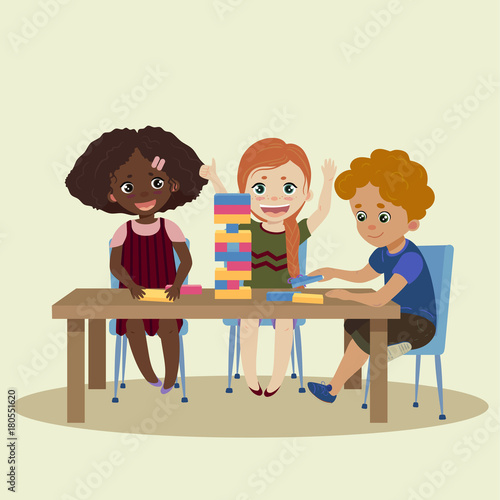 Jenga. Children play in wood block game jenga
