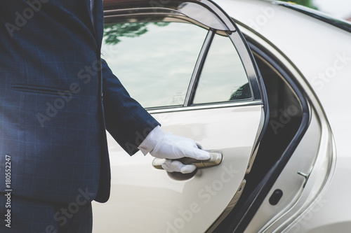 Fotografiet Businessman Handle Limousine Door Car