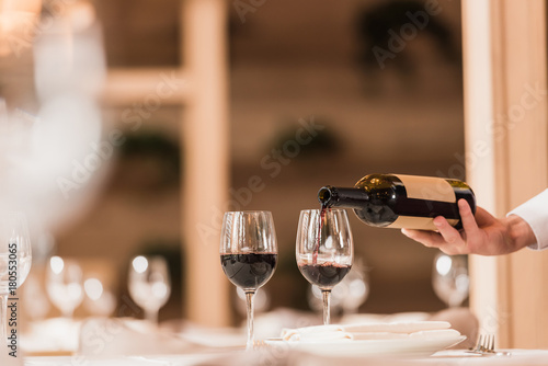 waiter pouring red wine