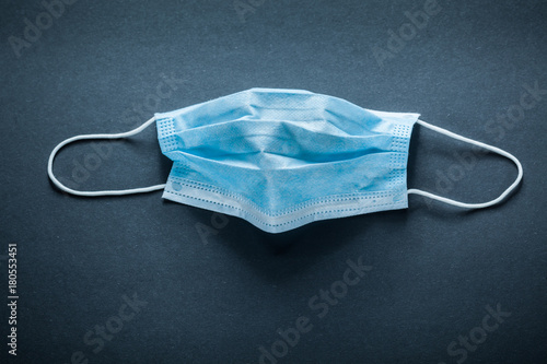 Disposable surgical mask on black background