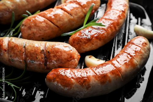 Fototapeta Grill pan with delicious grilled sausages, close up