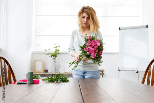 Photo of florist woman making bouquet