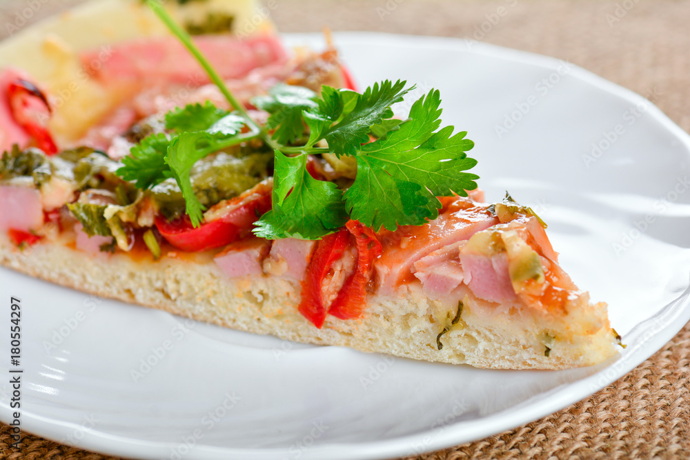 Piece of homemade pizza on a plate Piece of homemade pizza on a plate