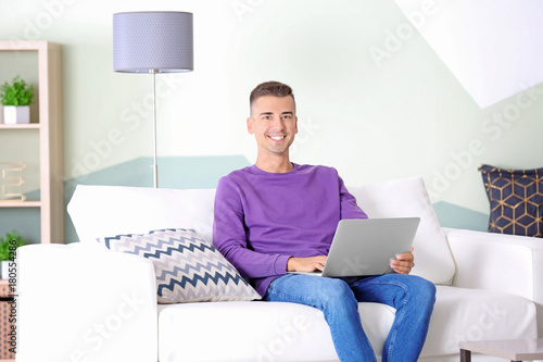 Smiling young man relaxing ...