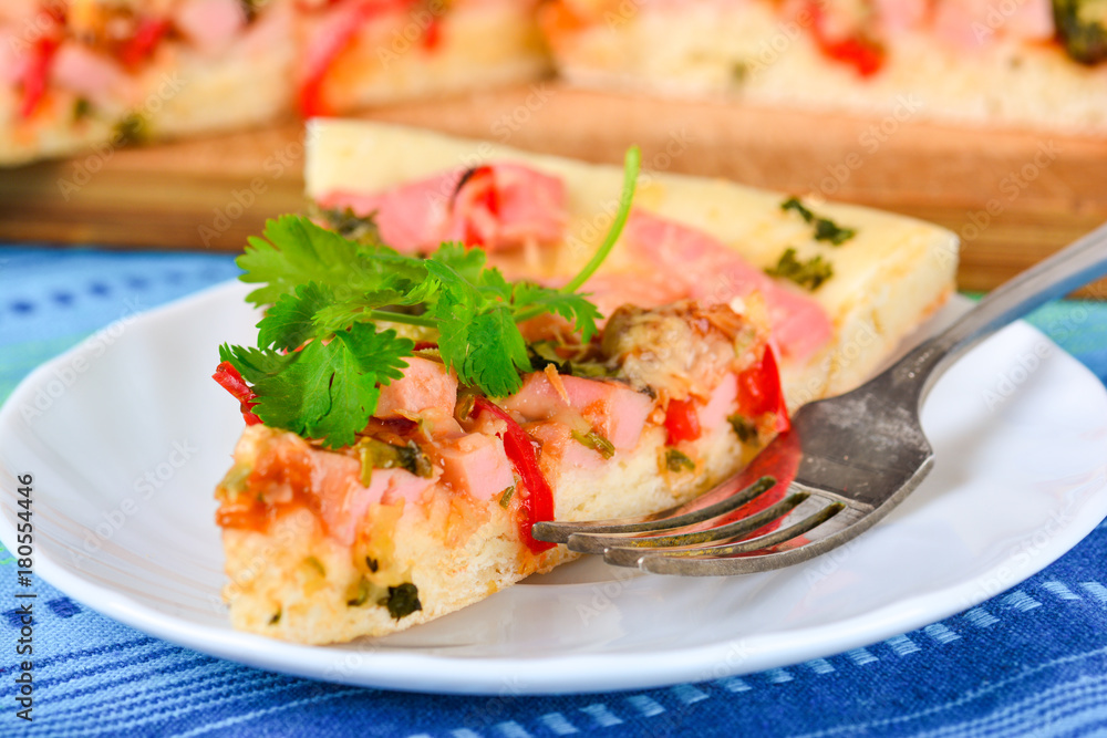 Piece of homemade pizza on a plate Piece of homemade pizza on a plate