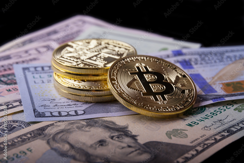 Golden bitcoin on dollar bills. Golden bitcoin on dollar bills.