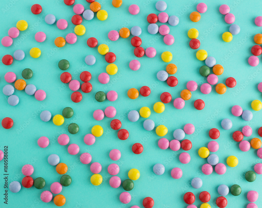 colorful chocolate candy pattern on mint blue background colorful chocolate candy pattern on mint blue background