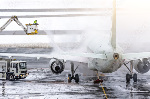 Ground crew provides de-icing. They are spraying the aircraft, which prevents the occurrence of frost. photo