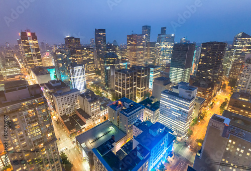 Night aerial view of Vancouver skyscrapers from city rooftop - British Columbia, Canada