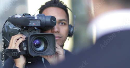 Cameraman filming for media broadcasting photo