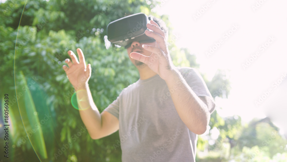 Young man wearing virtual reality glasses. Virtual reality concept, Smartphone and VR headset