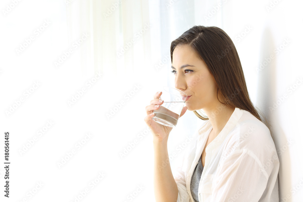 Woman drinking water isolated at side Woman drinking water isolated at side