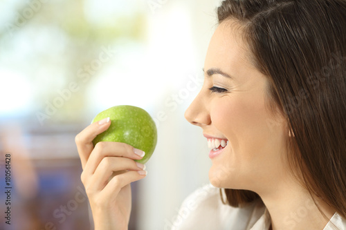Profile of a woman holding an apple