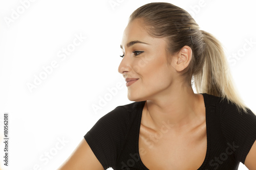 Profile portrait of a beautiful smiling teen girl on white background