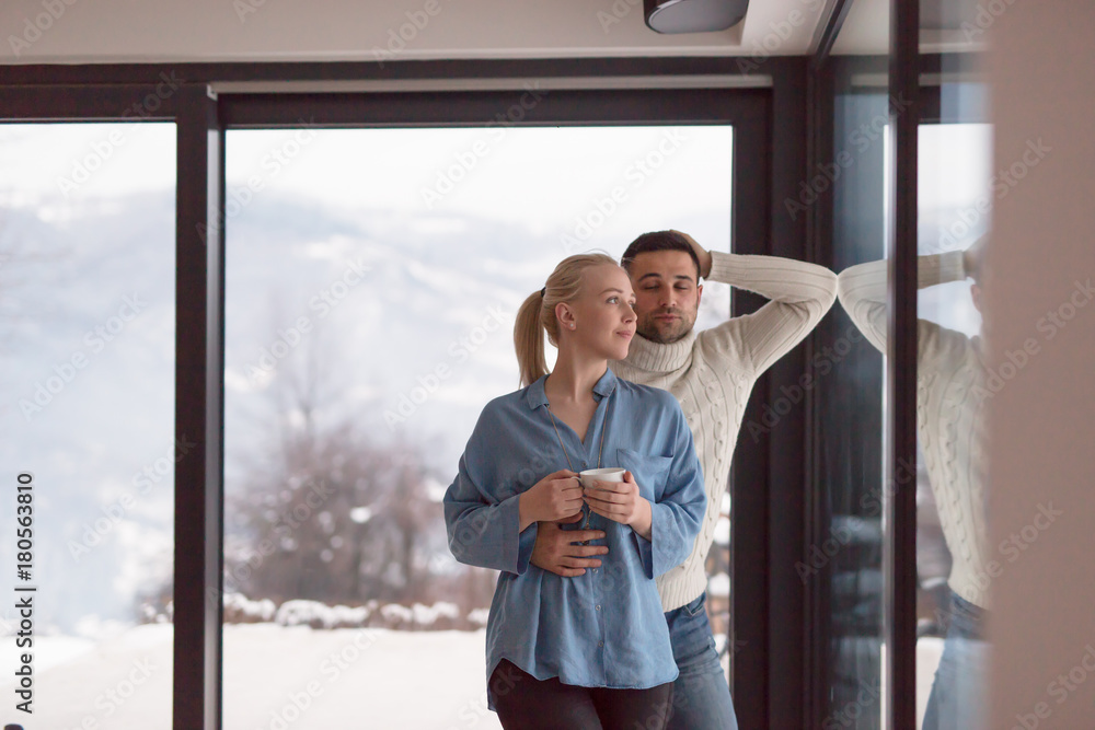 young couple enjoying evening tea by the window young couple enjoying evening tea by the window