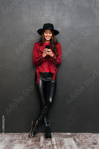 Smiling young beautiful woman chatting by mobile phone.
