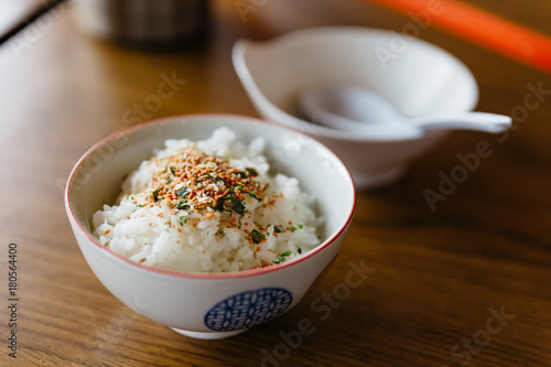 Steamed rice with Japanese seasoning rice flake in white bowl at the restaurant in Hokkaido, Japan.