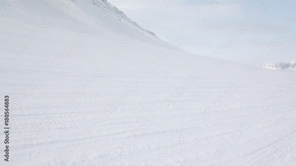 Snowmobile snow bike in North Pole Spitsbergen Svalbard Arctic. Way from airport Longyear to Pyramiden on background of glacier. Snowmobile snow bike in North Pole Spitsbergen Svalbard Arctic. Way from airport Longyear to Pyramiden on background of glacier.