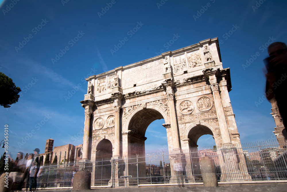 Arco of Costantino in Rome. Costantine arch of triumph in Rome with tourist moving fast around it