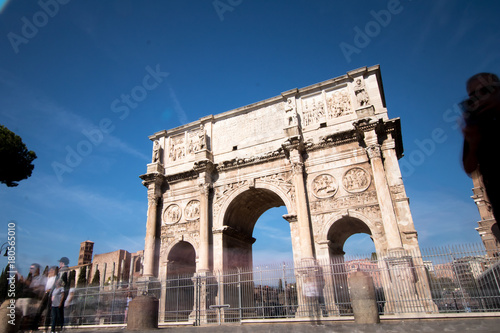 Arco of Costantino in Rome. Costantine arch of triumph in Rome with tourist moving fast around it