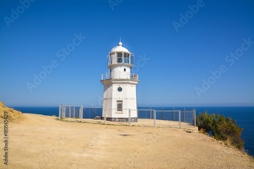 Classic lighthouse on a rock above the sea