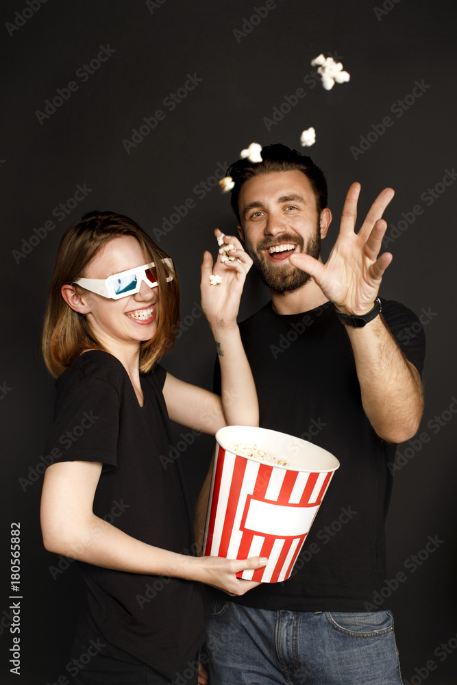 Fototapeta premium couple throwing popcorn at camera